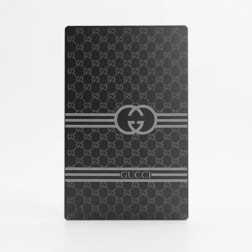 A black Gucci card case featuring the classic GG monogram pattern, a central interlocking GG logo, and the word 'GUCCI' printed near the bottom, set against a clean white background.