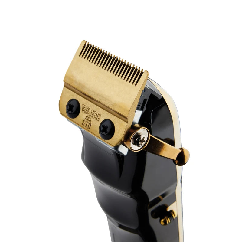 A close-up of a hair clipper showing the gold-toned metal comb plate and adjustment lever against a black body, on a clean white background.
