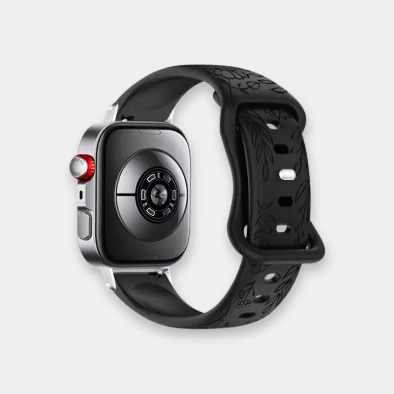 A smartwatch with a black silicone strap featuring a subtle leaf pattern, shown on a light gray background.